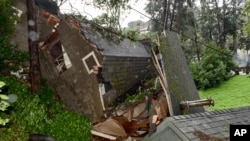 A crushed house is seen in the aftermath of a mudslide that destroyed three homes on a hillside in Sausalito, Calif., Feb. 14, 2019. 