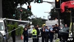 Police officers cordon off an area near the site of a shooting in central Auckland on July 20, 2023.