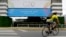 A man rides a bicycle past a banner promoting the G20 summit at the Costa Salguero Center, in Buenos Aires, Argentina, Nov. 27, 2018. 