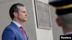 FILE - U.S. Defense Secretary Pete Hegseth prepares to welcome Australian Defense Minister and Deputy Prime Minister Richard Marles at the Pentagon near Washington, Feb. 7, 2025.