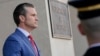 FILE - U.S. Defense Secretary Pete Hegseth stands at the entrance to the Pentagon, near Washington, Feb. 7, 2025.