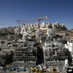 Houses under construction are seen in a Jewish settlement near Jerusalem known to Israelis as Har Homa and to Palestinians as Jabal Abu Ghneim, 08 Dec 2010