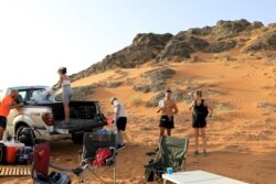 Peserta berdiri setibanya di hadapan sesi terapi mandi es di gurun dekat Sharjah, Uni Emirat Arab, 25 Juni 2021. (Foto: REUTERS/Rula Rouhana)