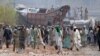 Supporters of the banned Islamist political party Tehreek-e-Labbaik Pakistan (TLP) with sticks and stones block a road during a protest in Lahore, Pakistan, Apr. 18, 2021. 