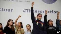 Climate activist Greta Thunberg, centre, stands with other young activists at the COP25 Climate summit in Madrid, Spain, Dec. 9, 2019.