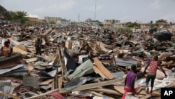 Residents salvage objects from houses demolished by government officials in Otodo-Gbame waterfront in Lagos Nigeria, March.18, 2017.