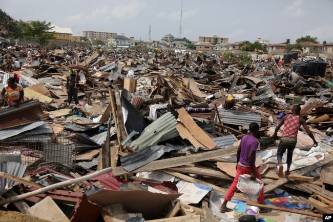 FILE - Residents salvage objects from houses demolished by government officials in Otodo-Gbame waterfront in Lagos Nigeria, March.18, 2017.