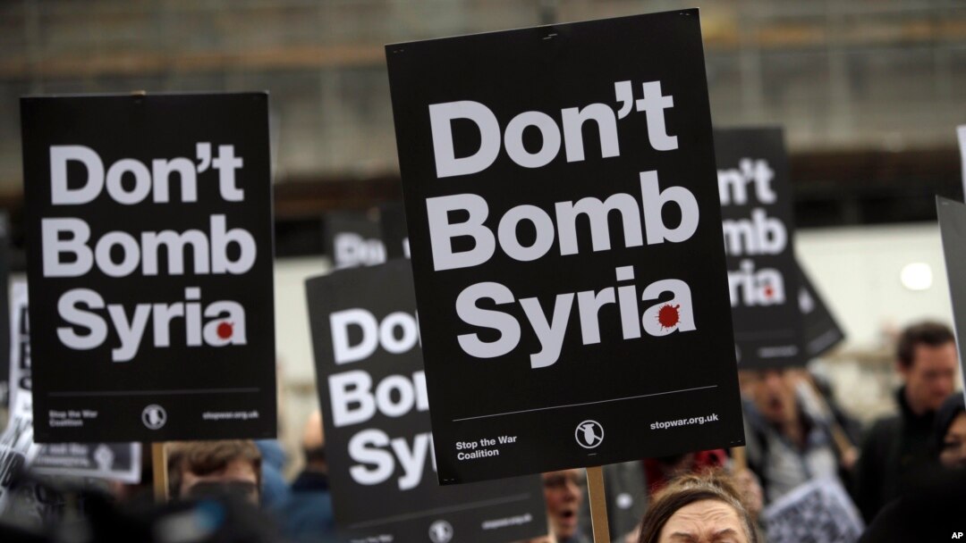 Protesters take part in a small demonstration organized by the Stop the War Coalition against possible military intervention or bombing by western allies in Syria, in London, April 13, 2018. 