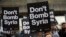 Protesters take part in a small demonstration organized by the Stop the War Coalition against possible military intervention or bombing by western allies in Syria, in London, April 13, 2018. 