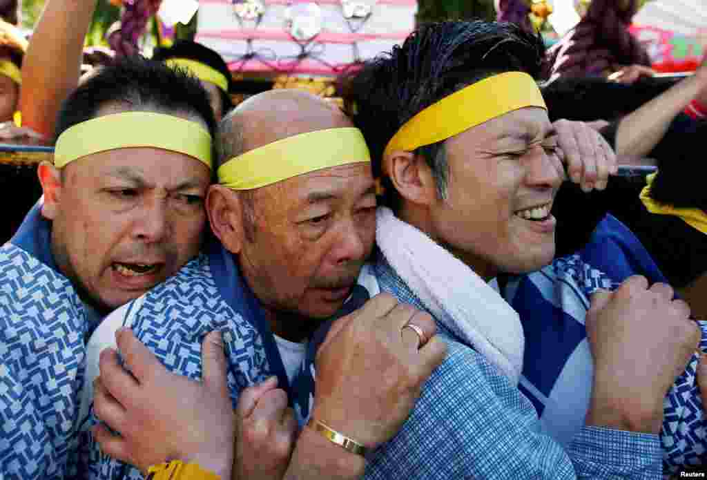 People carry a portable shrine, a Mikoshi, at the Senso-ji Temple during the Sanja festival in Asakusa district in Tokyo, Japan.