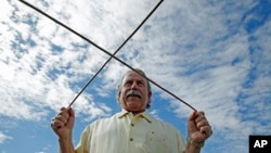 FILE - Marc Mondavi demonstrates dowsing to locate water at the Charles Krug winery in St. Helena, California. 