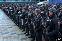 FILE - Albanian police forces line up in front of Elbasan Arena stadium where Albania will play its World Cup 2018 qualifying soccer match against Israel under tight security measures in Elbasan, 50 kilometers (30 miles) south of the capital, Tirana, Nov. 12, 2016.