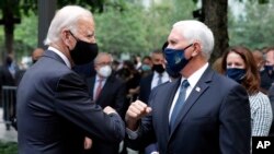 Democratic presidential candidate former Vice President Joe Biden greets Vice President Mike Pence at the 19th anniversary ceremony in observance of the Sept. 11 terrorist attacks at the National September 11 Memorial & Museum in New York, on Friday, Sept