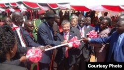 President Salva Kiir (center, with hat) and Japanese Ambassador to Juba Takeshi Akamatsu cut the ribbon at the groundbreaking in Juba to build a new bridge over the Nile.