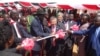 President Salva Kiir (center, with hat) and Japanese Ambassador to Juba Takeshi Akamatsu cut the ribbon at the groundbreaking in Juba to build a new bridge over the Nile.