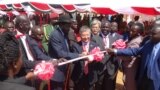 President Salva Kiir (center, with hat) and Japanese Ambassador to Juba Takeshi Akamatsu cut the ribbon at the groundbreaking in Juba to build a new bridge over the Nile.