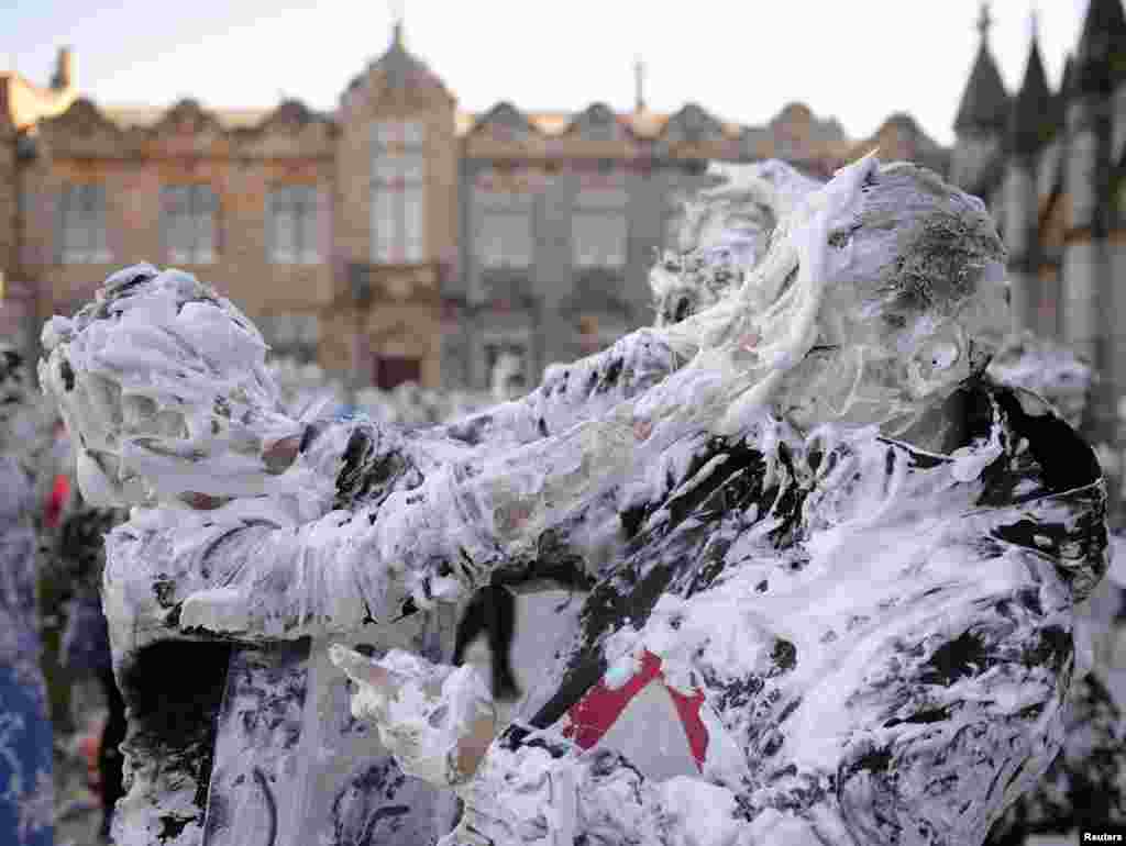 Students from St. Andrews University are covered in foam as they take part in the traditional 'Raisin Weekend' in the historic St. Salvator's Quad, in St Andrews, Scotland. 