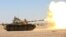 A tank operated by the government army fires at Houthi positions in the al-Labanat area, between Yemen's northern provinces of al-Jawf and Marib, Dec. 5, 2015.