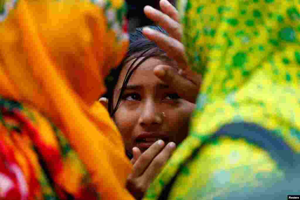 Relatives of victims killed in Rana Plaza building collapse in 2013, mourn at the site during the fourth anniversary of the collapse in Savar, on the outskirt of Dhaka, Bangladesh.