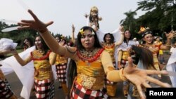 Balinese Hindu dancers perform during a ritual before Nyepi Day in Jakarta, Indonesia, March 20, 2015.