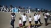 Family members wave as they arrive to take part in the 8th annual "Hugs not Walls" event on the Rio Grande, in Ciudad Juarez, Mexico, June 19, 2021. 