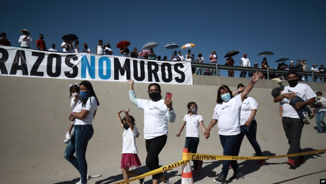 Family members wave as they arrive to take part in the 8th annual "Hugs not Walls" event on the Rio Grande, in Ciudad Juarez, Mexico, June 19, 2021. 