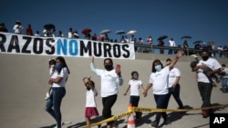 Family members wave as they arrive to take part in the 8th annual "Hugs not Walls" event on the Rio Grande, in Ciudad Juarez, Mexico, June 19, 2021. 