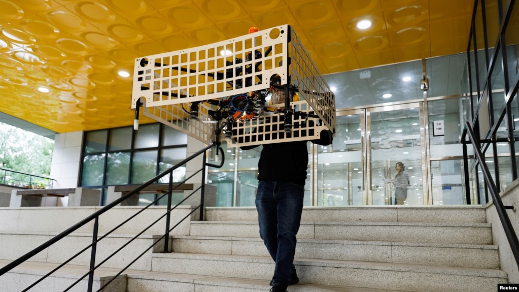 Park Hyun-geun, a graduate student of Mechanical Design and Robot Engineering at Seoul National University of Science and Technology, demonstrates the transporter drone in Seoul, South Korea, October 10, 2024. (REUTERS/Kim Soo-hyeon)