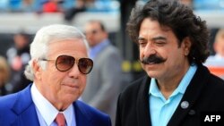 New England Patriots owner Robert Kraft (L) speaks with Shahid Kahn, owner of the Jacksonville Jaguars, before a game between the two teams in Jacksonville, Florida, Dec. 23, 2012.