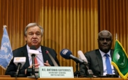 FILE - U.N. Secretary General Antonio Guterres, left, and the African Union Commission Chairperson Moussa Faki Mahamat attend a news conference at the African Union Commission headquarters in Addis Ababa, Ethiopia, July 9, 2018.