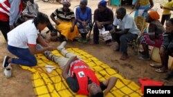 A nurse from Kenya snakebite research and intervention centre shows how a snakebite victim should be handled during a snakebite sensitisation exercise at Malalani village in Mwingi, Kenya October 24, 2019. (REUTERS/Njeri Mwangi)