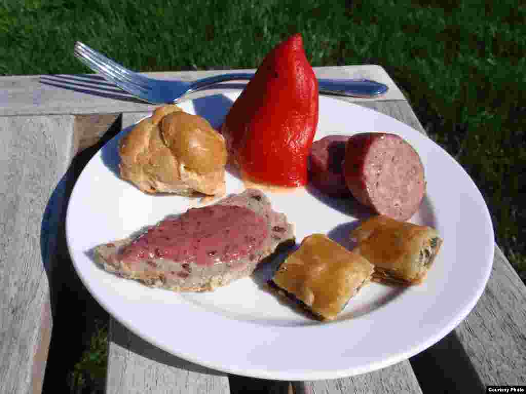 Crayfish-stuffed piquillo pepper, sorrel smoked salmon puff, wild turkey terrine with blackberry mustard, dandlion spanakopita and wild boar bratwurst. (Tom Banse)