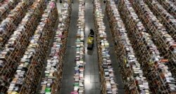 FILE - A worker gathers items for delivery from the warehouse floor at Amazon's distribution center in Phoenix, Arizona, Nov. 22, 2013.