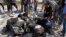 This photo provided by the Syrian Civil Defense White Helmets shows civil defense workers searching in the rubble after airstrikes hit in Khan Sheikhoun, in the northern province of Idlib, Syria, Sept, 24, 2017.