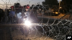 Egyptian Army soldiers install barbed wire outside the presidential palace to secure the site of overnight clashes between supporters and opponents of President Mohammed Morsi in Cairo, Egypt, Thursday, Dec. 6, 2012.