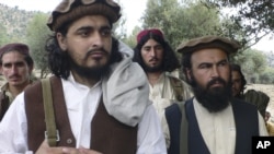 FILE - Pakistani Taliban chief Hakimullah Mehsud, left, is seen with his comrade Waliur Rehman during his meeting with media in Sararogha of Pakistani tribal area of South Waziristan along the Afghanistan border, Oct. 4, 2009.
