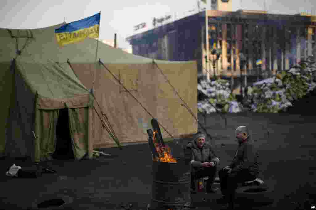 Opposition supporters warm themselves around a fire in Kyiv's Independence Square, Feb. 24, 2014. 