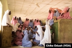 The students of the Dapchi girls school relax and hang out in their dorm room on a Saturday.