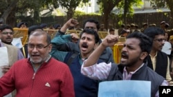 FILE - Indian journalists shout slogans for the freedom of press near Supreme Court in New Delhi, India Tuesday, Feb. 16, 2016.