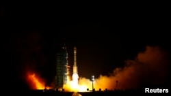 FILE - The Long March II-F rocket loaded with China's unmanned space module Tiangong-1 lifts off from the launch pad in the Jiuquan Satellite Launch Center, Gansu province.