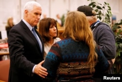 U.S. Vice President Mike Pence and his wife, Karen, greet a couple at Floresville High School during a visit with family and victims of the shooting at First Baptist Church in Sutherland Springs, before a vigil in Floresville, Texas, Nov. 8, 2017.