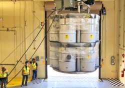 FILE - Barrels of radioactive waste are loaded for transport to the Waste Isolation Pilot Plant, at the Radioactive Assay Nondestructive Testing (RANT) facility in Los Alamos, N.M., April 9, 2019.