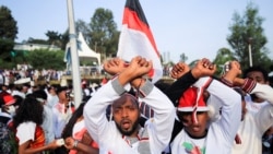People show the Oromo Protest gesture as they chant anti-government slogans during Irreechaa Festival, the Oromo People thanksgiving ceremony at the Hora Finfinnee, in Addis Ababa, Ethiopia, Oct. 2, 2021.