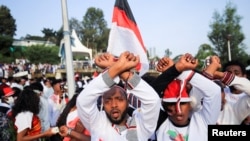 FILE: People show the Oromo Protest gesture as they chant anti-government slogans during Irreechaa Festival, the Oromo People thanksgiving ceremony at the Hora Finfinnee, in Addis Ababa, Ethiopia, Oct. 2, 2021. 