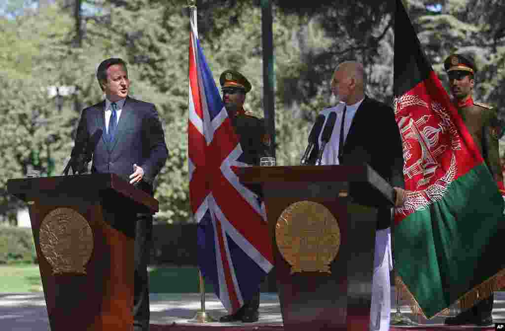 Afghanistan's president Ashraf Ghani Ahmadzai, right, listens as Britain's Prime Minister David Cameron talks during a news conference at the presidential palace in Kabul, Afghanistan, Friday, Oct. 3, 2014.