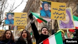 People demonstrate in solidarity with anti-government protests in Iran near the Iranian embassy in Paris, France, Jan. 6, 2018. 