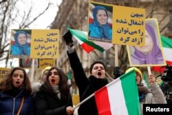 People demonstrate in solidarity with anti-government protests in Iran near the Iranian embassy in Paris, France, Jan. 6, 2018.