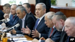 Israel's Prime Minister Benjamin Netanyahu, center, speaks during the weekly cabinet meeting in Jerusalem, Jan. 31, 2016. 
