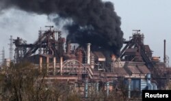 FILE PHOTO: Smoke rises above a plant of Azovstal Iron and Steel Works in Mariupol