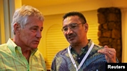 Menteri Pertahanan Chuck Hagel (kiri) mendengarkan penjelasan dari Menteri Pertahanan dan penjabat Menteri Perhubungan Malaysia Hishammuddin Hussein dalam pertemuan menteri-menteri pertahanan Asia Tenggara di Honolulu, Hawaii (1/4). (Reuters/Alex Wong)